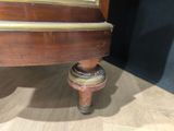 a close up of a wooden table with a clock on top of it