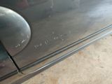 a close up of a car door handle with a sticker on it