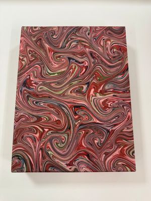 a painting of a red and green swirl on a white surface