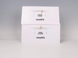 two white boxes with black writing on them sitting on a table
