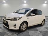 La Toyota Yaris est garée dans une salle blanche dont le sol est recouvert d'un revêtement à carreaux.