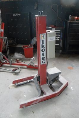 a picture of a red machine that is in a garage