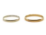 two gold and silver wedding bands on a white background