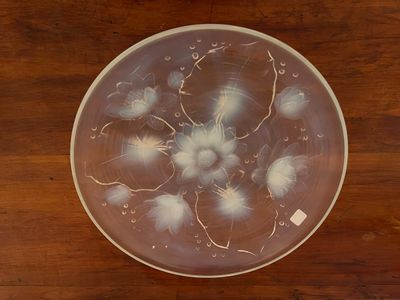 a glass plate with a lot of water in it on a wooden table