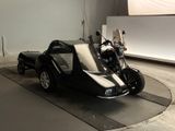 a black motorcycle with a side car in a room