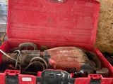 a red tool box with tools in it on a table