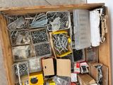 a wooden box filled with assorted screws and nuts