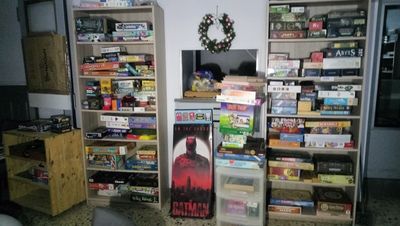 a refrigerator in the corner of a room with a lot of shelves