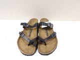 black birketts sandals with buckles and straps on them
