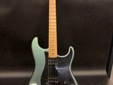 a green electric guitar sitting on top of a table