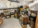 a lot of old radio ' s and other items in this room
