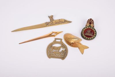 several different types of metal items are displayed on a white surface