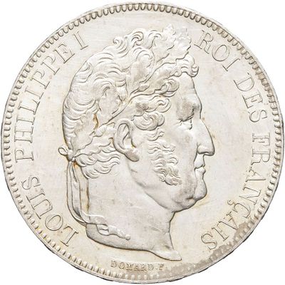 a close up of a silver coin with a man ' s head on it