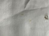 a close up of a white shirt with buttons on it