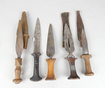 several different types of knives are lined up on a white surface