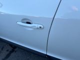 a close up of a door handle on a white car