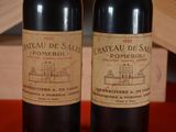 two bottles of wine sitting next to each other on a table