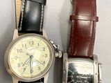two watches sitting next to each other on a table
