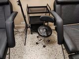 two black chairs in a room with a microphone and a chair
