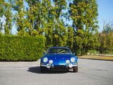 a blue car that is parked in a parking lot
