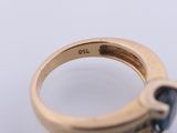 a close up of a gold ring with a blue stone in it