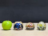 three glass vases that are sitting on a table