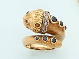 a gold ring with a snake on it and a diamond ring on the side