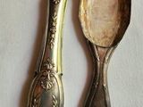 two spoons sitting next to each other on a table