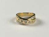 a close up of a gold ring with diamonds on a white surface