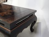 a black table with a wooden top on a white floor