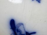 a blue and white vase sitting on a table