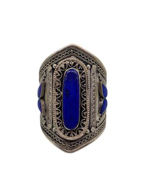 a close up of a ring with a blue stone in it