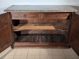 a wooden cabinet with a marble top in a room