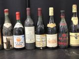 several bottles of wine are lined up in a row on a table