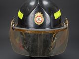 a close up of a fireman ' s helmet on a black background