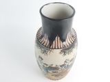 a black and white vase with a painting on it
