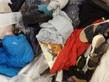 a pile of clothes and other items in a plastic bag