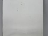 a white piece of paper with a blue sticker on it