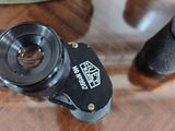 a close up of a camera on a table next to a helmet