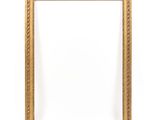 a gold frame with a decorative pattern on a white background