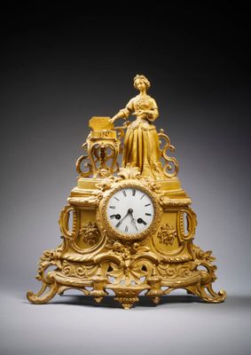 an image of a gold clock sitting on top of a table