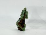 a figurine of a man sitting on a chair