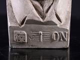 a silver statue of a man with a beard and mustache