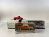 three boxed toy cars are sitting on top of a table