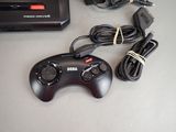 a game controller sitting next to a game system on a table