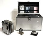 a silver box with a camera and some other items