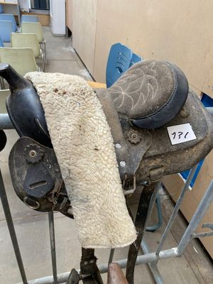 a horse saddle with a blanket on it in a room