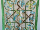 une écharpe verte et bleue ornée d'oiseaux et de fleurs