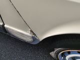 a close up of a white car with a flat tire