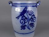 a blue and white vase with a bird on it